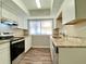 Bright kitchen featuring granite countertops, stainless steel appliances, and white cabinets at 927 Pine Oak Trl, Austell, GA 30168