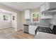 Updated kitchen with stainless steel appliances, white cabinets, and gray countertops at 1700 John Calvin Ave, Atlanta, GA 30337