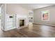 Sun-filled living room with hardwood floors, fireplace, and built-in shelving at 1700 John Calvin Ave, Atlanta, GA 30337