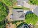 Overhead view of a house and property with lush landscaping, driveway, and backyard with a firepit at 210 Cole Ct, Canton, GA 30114