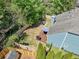 Aerial view of a fenced backyard with deck, fire pit, lawn, and privacy landscaping at 210 Cole Ct, Canton, GA 30114