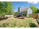 This backyard features a wooden deck, privacy fence, and green landscaping at 210 Cole Ct, Canton, GA 30114