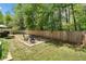 Spacious backyard featuring a firepit area, wood fence, and a serene outdoor setting at 210 Cole Ct, Canton, GA 30114