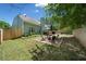Fenced backyard with a deck, firepit, and outdoor seating, ideal for relaxing and entertaining at 210 Cole Ct, Canton, GA 30114