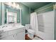 This is a full bathroom with a shower over tub, toilet, sink, and wall mirror at 210 Cole Ct, Canton, GA 30114