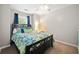 Bedroom featuring a ceiling fan, a decorated queen bed, and a window with blue curtains at 210 Cole Ct, Canton, GA 30114
