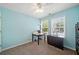 Bedroom featuring an open floor plan, with 2 windows, light blue walls, and ceiling fan at 210 Cole Ct, Canton, GA 30114