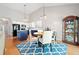 Open floor plan showcases the kitchen and dining area with hardwood floors and a modern light fixture at 210 Cole Ct, Canton, GA 30114