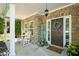 Charming front porch with stone accents, rocking chairs, and a welcoming entrance at 210 Cole Ct, Canton, GA 30114