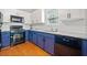 Updated kitchen showcases white cabinets, granite countertops, stainless steel appliances, and tiled backsplash at 210 Cole Ct, Canton, GA 30114