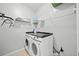 Bright laundry room with front loading washer and dryer and wire shelving for storage at 210 Cole Ct, Canton, GA 30114