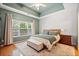 Spacious main bedroom with a ceiling fan, area rug, and lots of natural light from a large window at 210 Cole Ct, Canton, GA 30114