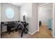 Office with a unique round window and neutral walls, located off of a bedroom at 210 Cole Ct, Canton, GA 30114