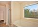 An attached bath features a garden tub with a window and a separate glass enclosed shower at 4354 Favored Way, Union City, GA 30291