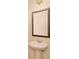 A pedestal sink and framed mirror highlight a well-lit half bathroom at 4354 Favored Way, Union City, GA 30291