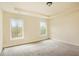A carpeted bedroom features two windows that let in natural light and neutral colored walls at 4354 Favored Way, Union City, GA 30291