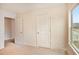 A carpeted bedroom has an entry to another room and a window that lets in natural light at 4354 Favored Way, Union City, GA 30291