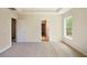 A carpeted bedroom with neutral walls features an entry and a door that opens into a walk-in closet at 4354 Favored Way, Union City, GA 30291