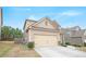 A two-story house featuring beige siding and a two-car garage on a sunny day at 4354 Favored Way, Union City, GA 30291
