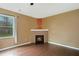 Cozy living room with a fireplace, hardwood floors, and a large window at 4354 Favored Way, Union City, GA 30291