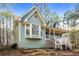 Charming home featuring a covered front porch, dormer windows, and light blue siding at 495 Stratford Dr, Douglasville, GA 30134