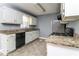 Galley kitchen featuring white cabinets, granite countertops and stainless appliances at 495 Stratford Dr, Douglasville, GA 30134