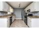 Galley kitchen with white cabinets, granite countertops and stainless appliances at 495 Stratford Dr, Douglasville, GA 30134