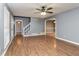 Spacious living room with hardwood floors, ceiling fan and staircase at 495 Stratford Dr, Douglasville, GA 30134