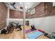 Exposed brick wall basement gym with hardwood floors, ceiling fans, and exercise equipment at 65 Peachtree Memorial Nw Dr # 5, Atlanta, GA 30309