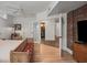 Bright bedroom featuring brick accent wall, hardwood floors, and doorway to en-suite bathroom at 65 Peachtree Memorial Nw Dr # 5, Atlanta, GA 30309