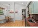 Bright kitchen nook with a built-in banquette, hardwood floors, and brick wall accent at 65 Peachtree Memorial Nw Dr # 5, Atlanta, GA 30309