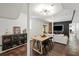 Open-concept living room with wood floors, modern lighting, and built-in bar area for entertaining at 65 Peachtree Memorial Nw Dr # 5, Atlanta, GA 30309