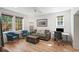 Well-lit living room featuring hardwood floors, stylish furniture, and comfortable workspace at 65 Peachtree Memorial Nw Dr # 5, Atlanta, GA 30309