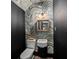 Stylish powder room featuring unique wallpaper, black accent walls, and modern fixtures at 65 Peachtree Memorial Nw Dr # 5, Atlanta, GA 30309