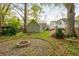 Backyard with a fire pit, featuring lush greenery and flowering shrubs, creating a relaxing outdoor oasis at 68 Spence Se Ave, Atlanta, GA 30317