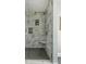 Elegant walk-in shower featuring gray-patterned walls, a built-in seat, and sleek fixtures for a modern spa-like experience at 68 Spence Se Ave, Atlanta, GA 30317