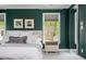 Bedroom featuring a comfy bed, window with blind, a mirror, and a nightstand with lamp for a cozy retreat at 68 Spence Se Ave, Atlanta, GA 30317