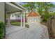 Detached two-car garage with carriage doors, alongside a charming covered patio area in a well-maintained backyard at 68 Spence Se Ave, Atlanta, GA 30317