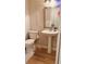 Half bathroom featuring sleek fixtures, pedestal sink, and neutral decor at 115 Winding River Dr # B, Atlanta, GA 30350