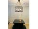 Dining room with hanging light fixture over wooden table at 115 Winding River Dr # B, Atlanta, GA 30350