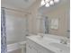 Well-lit bathroom features a double sink vanity and a shower-tub combination at 302 Wickley Way, Woodstock, GA 30188