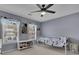 Bright bedroom with large windows, ceiling fan, and playful decor at 302 Wickley Way, Woodstock, GA 30188