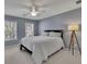 Cozy bedroom featuring neutral carpet, ceiling fan, and windows that let in plenty of natural light at 302 Wickley Way, Woodstock, GA 30188
