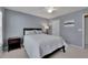 Comfortable bedroom features a ceiling fan, neutral carpet, and a window for natural light at 302 Wickley Way, Woodstock, GA 30188