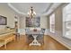 Formal dining room featuring a stylish chandelier, a gray table set, and hardwood flooring at 302 Wickley Way, Woodstock, GA 30188