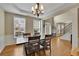 Elegant dining area with stylish chandelier, natural light, and views into the foyer and entryway at 302 Wickley Way, Woodstock, GA 30188