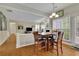 Dining room with hardwood floors, view of living room, and backyard access at 302 Wickley Way, Woodstock, GA 30188