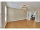 Spacious room with neutral walls, wood floors, and an adjoining room with French doors at 302 Wickley Way, Woodstock, GA 30188