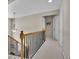 Upstairs hallway with neutral walls, carpeted floors, and attractive railings at 302 Wickley Way, Woodstock, GA 30188