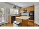 Eat-in kitchen with granite countertops, stainless appliances and hardwood floors at 302 Wickley Way, Woodstock, GA 30188